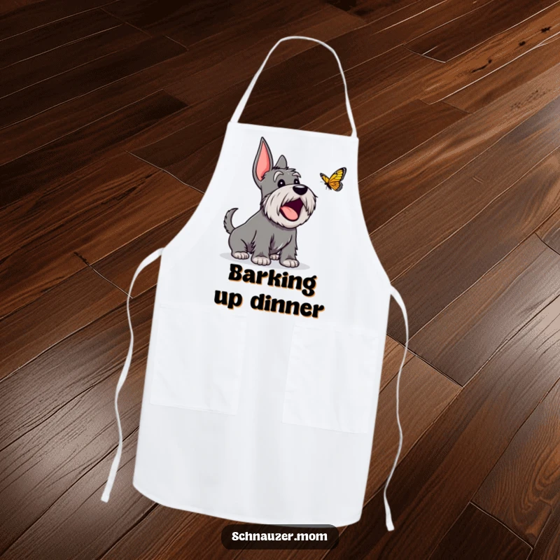 Funny Schnauzer apron showing an excited dog character happily barking at a butterfly, ideal for a joyful cook.