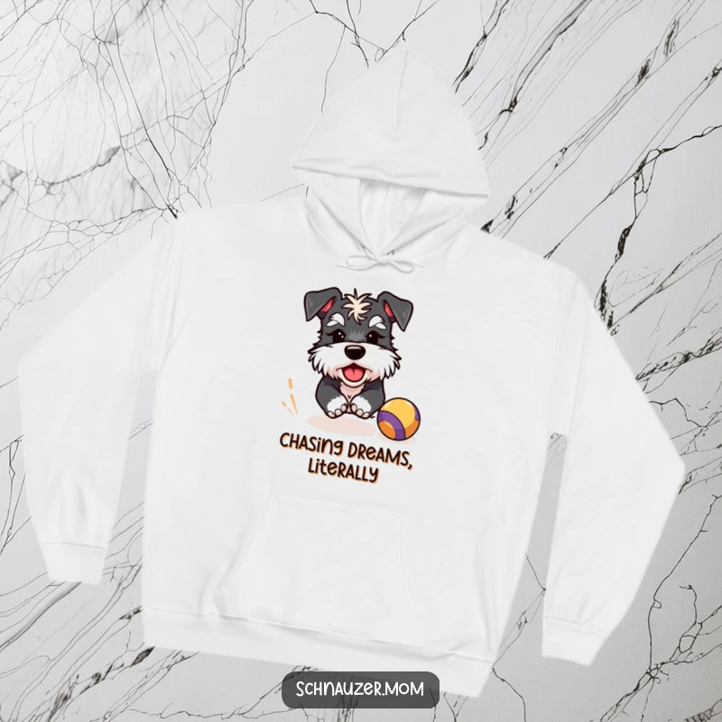Funny Schnauzer hoodie featuring a winking dog character in full pursuit of a bouncing ball, radiating playful energy and joy.