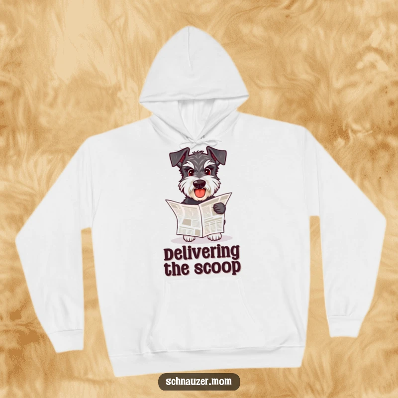 Funny Schnauzer dog fetching a small newspaper, looking cozy and content in a hooded sweatshirt.