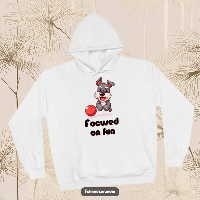 Funny Schnauzer hoodie of a playful dog with a determined grin chasing a bouncing red ball with focused energy.