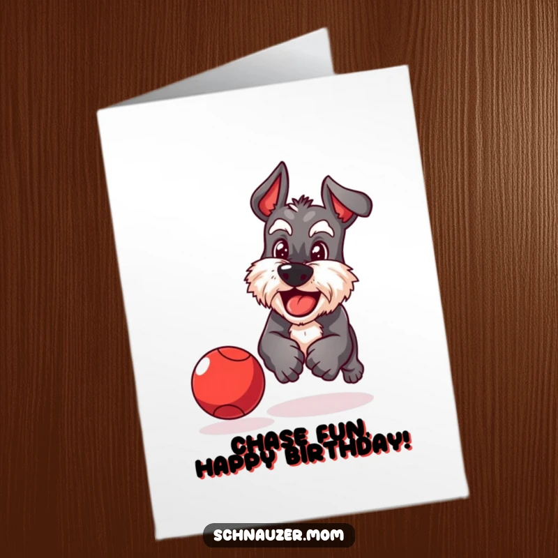 Funny Free Printable Birthday Card: A playful Schnauzer dog is determinedly chasing a bouncing red ball with a happy grin.